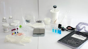 Chemistry lab kit items on a white background