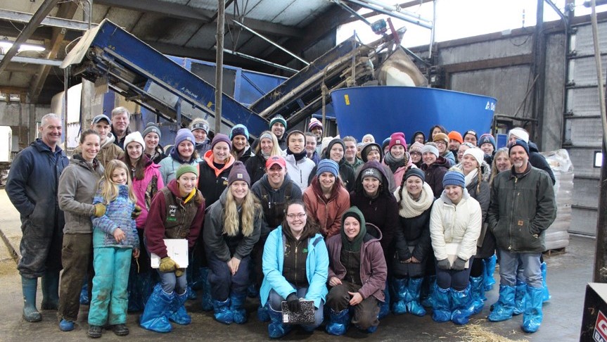 umaine students visiting a dairy during a travel course
