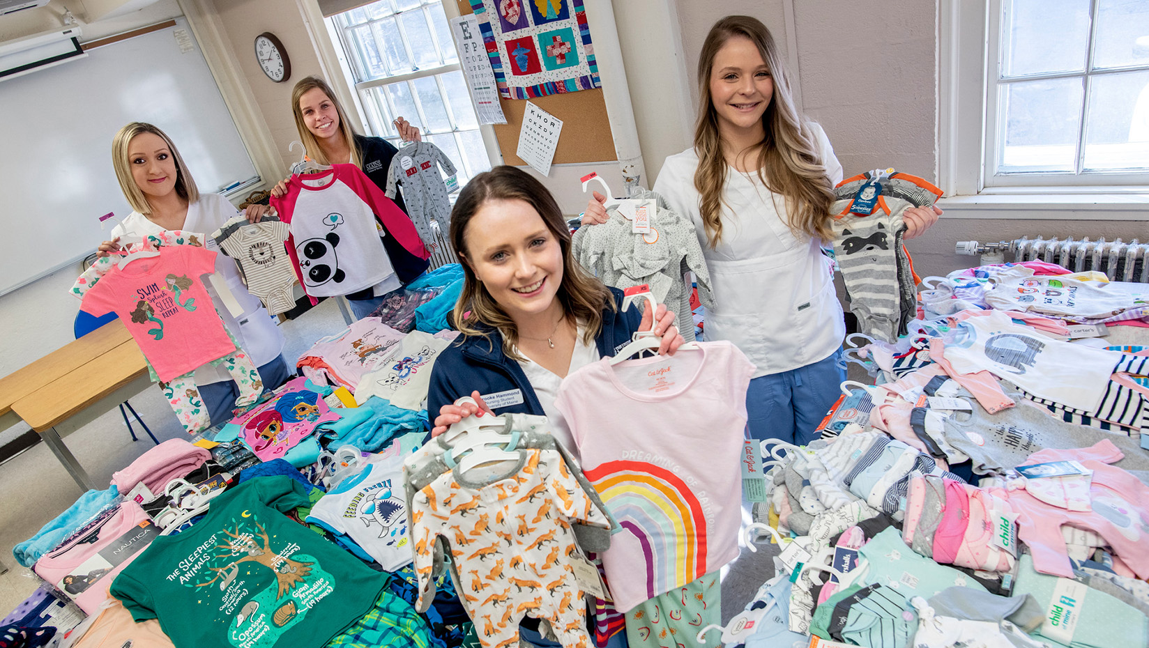 Nursing students pose with the pajamas they collected