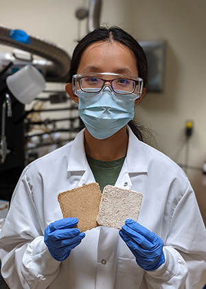 Wenjing Sung in the laboratory holding two composites.